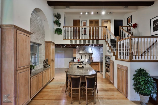 kitchen featuring a center island, a high ceiling, and a breakfast bar