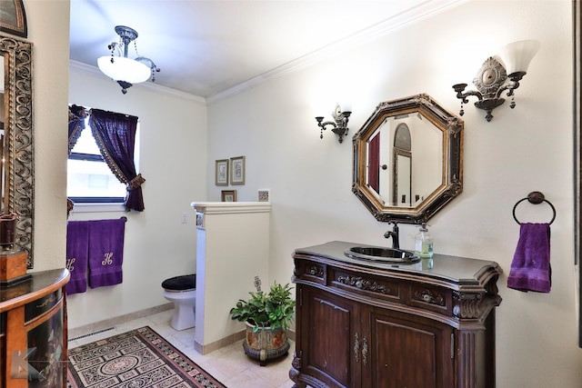 bathroom with crown molding, vanity, tile patterned floors, and toilet