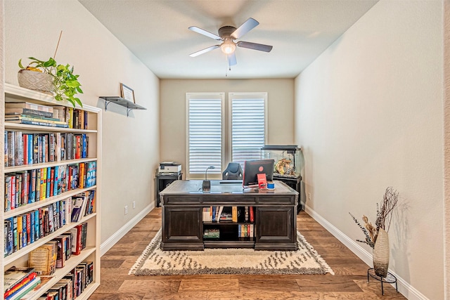 office space with wood finished floors, baseboards, and ceiling fan