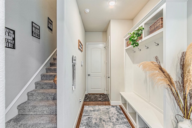 mudroom featuring baseboards and wood finished floors