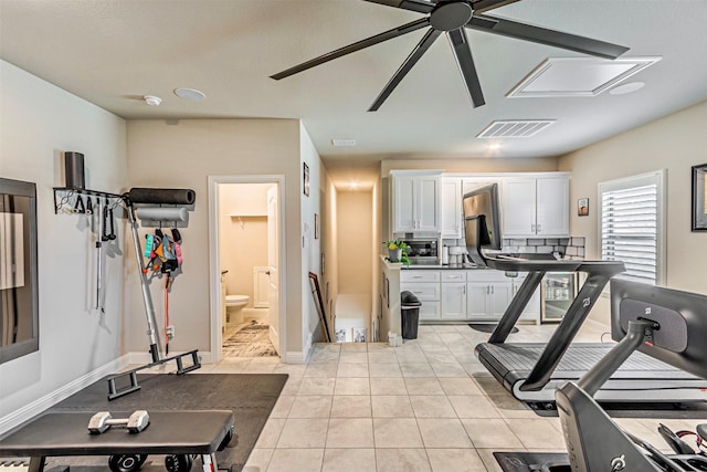 workout room featuring light tile patterned flooring, visible vents, baseboards, and ceiling fan