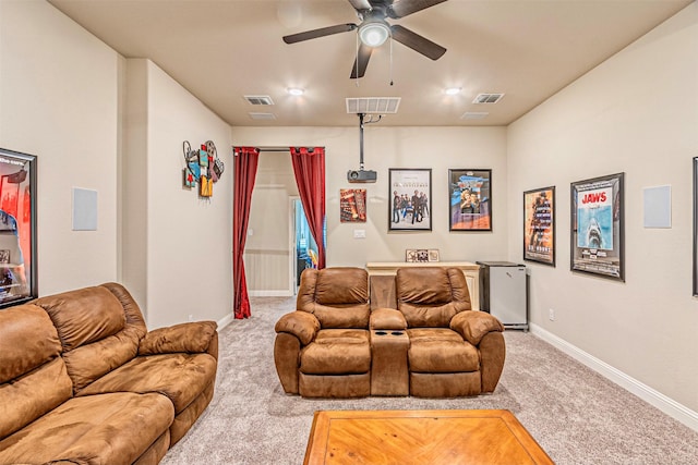 carpeted cinema with baseboards, visible vents, and ceiling fan