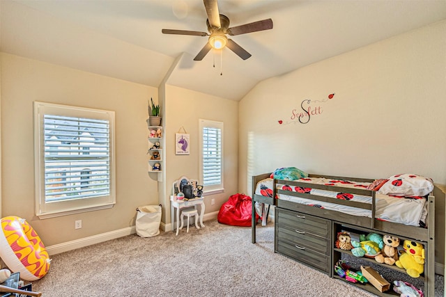 carpeted bedroom with vaulted ceiling, baseboards, and ceiling fan