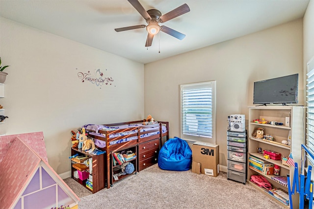 carpeted bedroom with baseboards and a ceiling fan