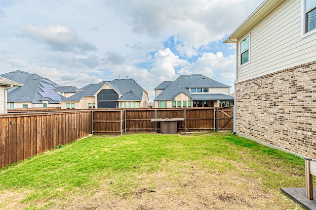 view of yard featuring a residential view and a fenced backyard