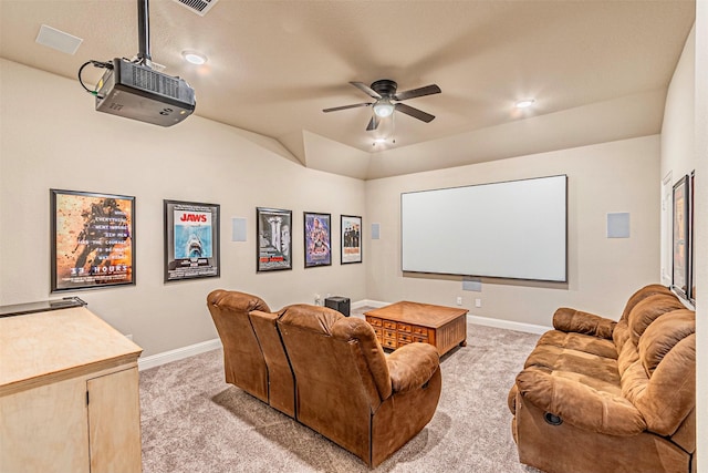 home theater with visible vents, baseboards, lofted ceiling, ceiling fan, and light colored carpet