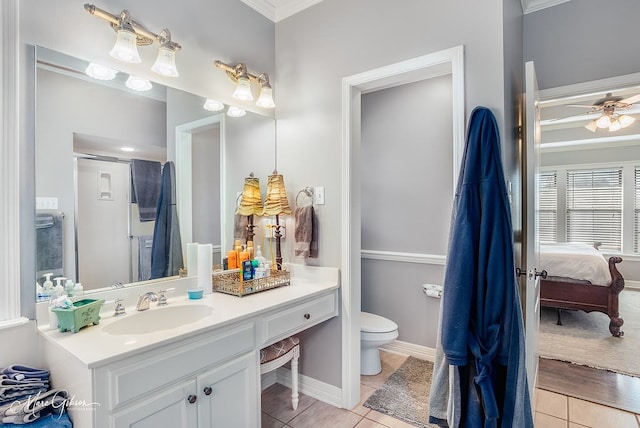 bathroom featuring tile patterned flooring, vanity, ceiling fan, and toilet