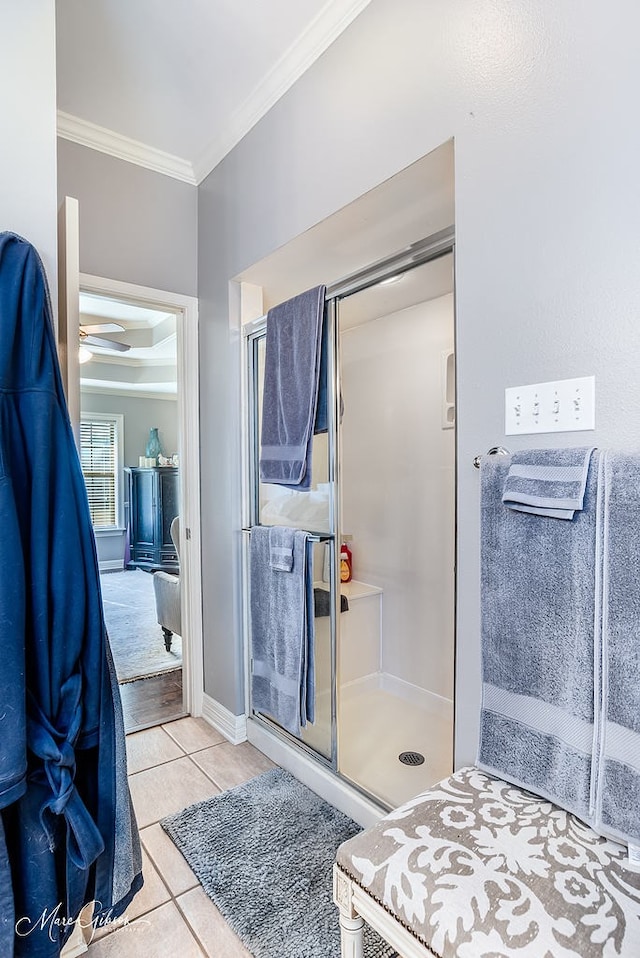 bathroom with walk in shower, ornamental molding, and tile patterned flooring