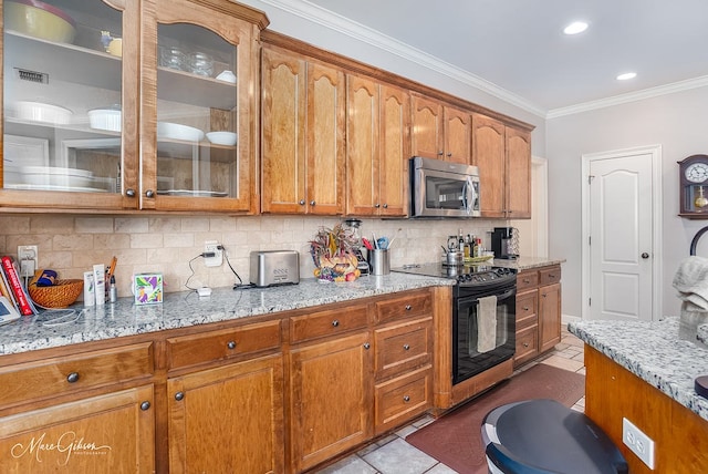 kitchen with light tile patterned flooring, ornamental molding, light stone counters, and black range with electric cooktop