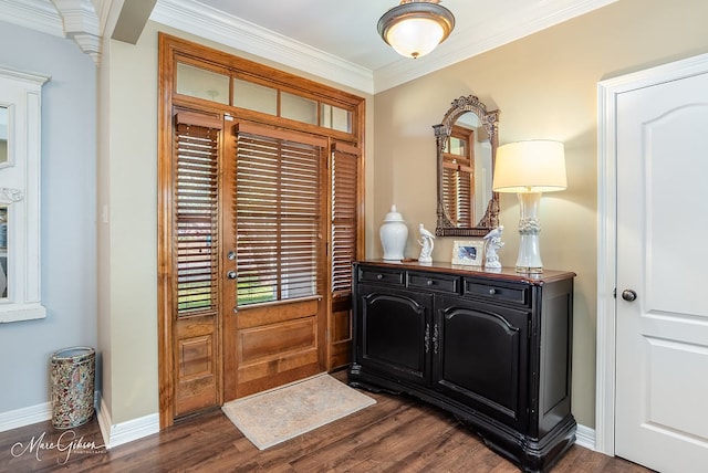 foyer featuring dark wood-type flooring, ornamental molding, and ornate columns