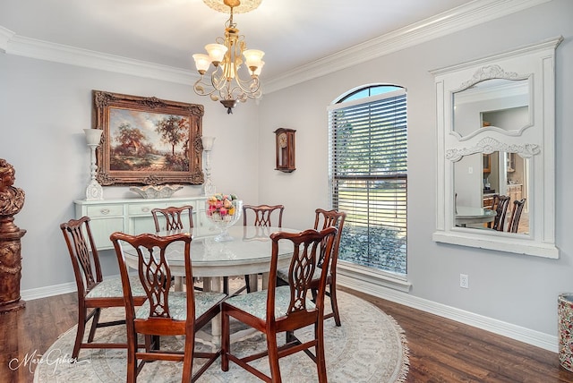 dining space featuring ornamental molding, hardwood / wood-style floors, and an inviting chandelier