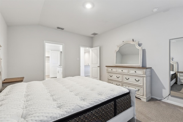 carpeted bedroom featuring connected bathroom and vaulted ceiling