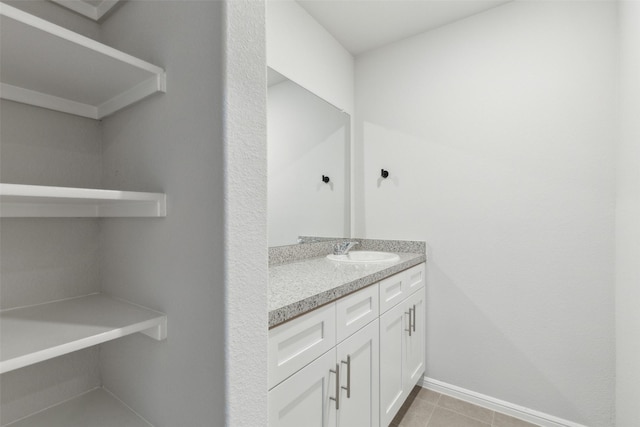 bathroom featuring tile patterned flooring and vanity