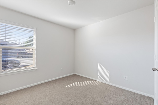 spare room with light colored carpet