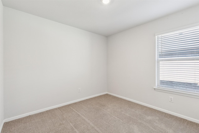 empty room featuring light carpet