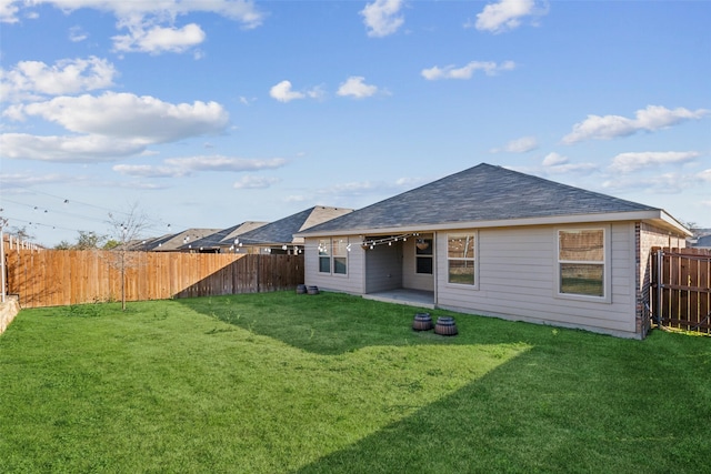 rear view of house featuring a patio area and a lawn