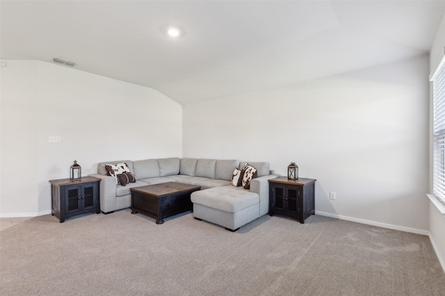 carpeted living room with lofted ceiling