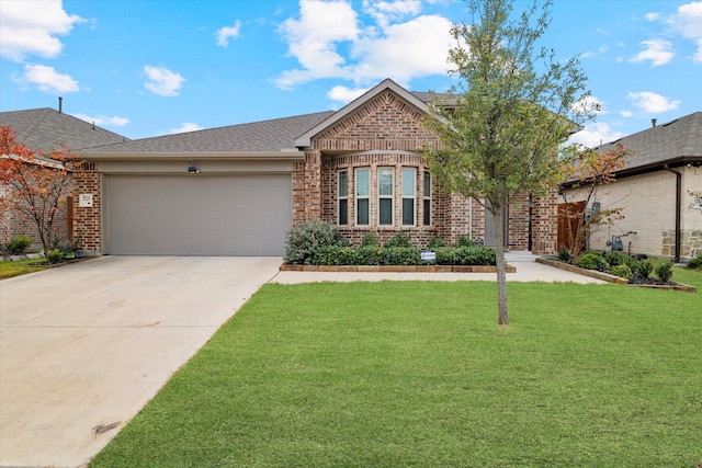 view of front of house featuring a garage and a front lawn