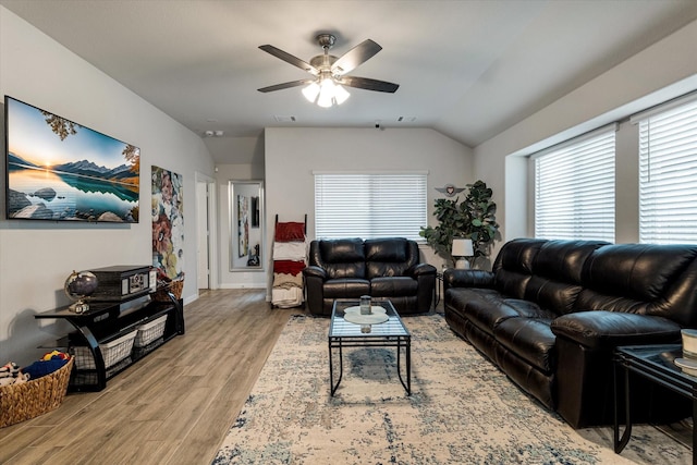 living room with ceiling fan, a healthy amount of sunlight, lofted ceiling, and light hardwood / wood-style floors