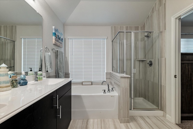 bathroom featuring vanity and separate shower and tub