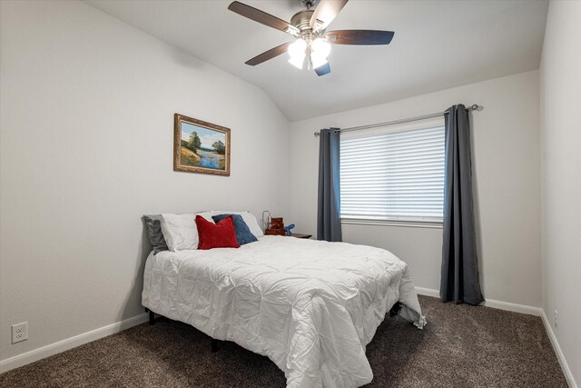 bedroom with dark colored carpet, ceiling fan, and lofted ceiling