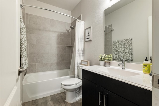 full bathroom with shower / bath combo, vanity, hardwood / wood-style flooring, and toilet