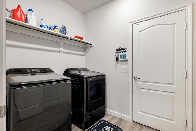 laundry room featuring light wood-type flooring and washing machine and dryer