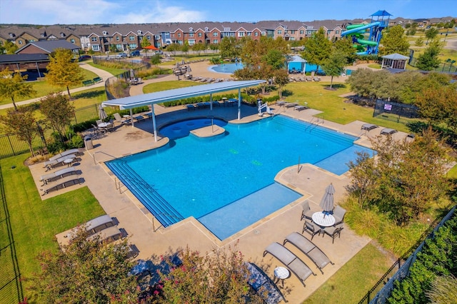 view of swimming pool featuring a patio and a water slide