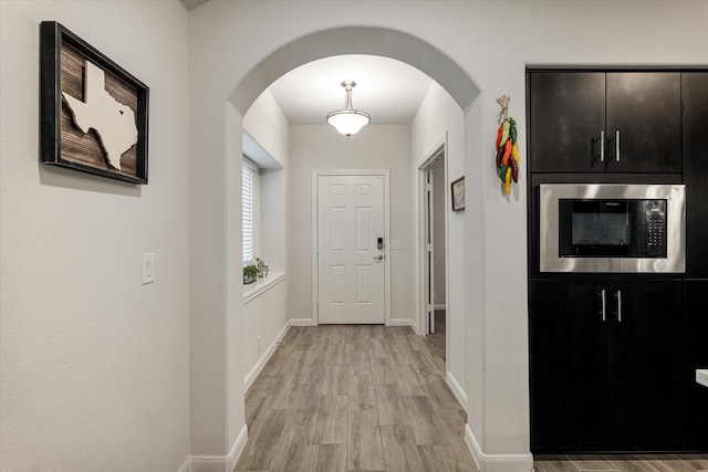 hall with light hardwood / wood-style flooring