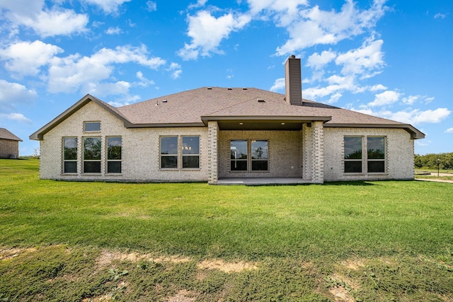 back of house featuring a patio area and a yard