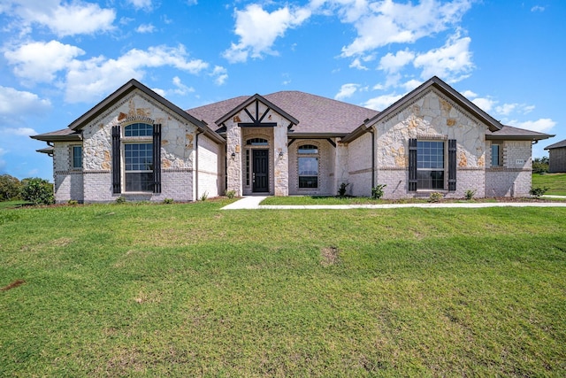 view of front of home with a garage and a front lawn