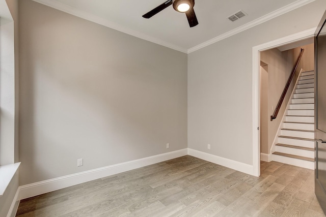 empty room featuring ceiling fan, ornamental molding, and light wood-type flooring