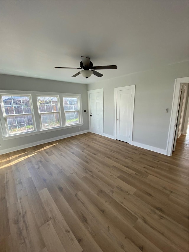 unfurnished room with ceiling fan and wood-type flooring