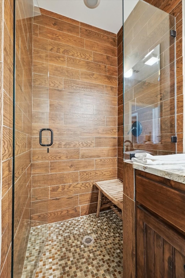 bathroom featuring vanity and a shower with shower door