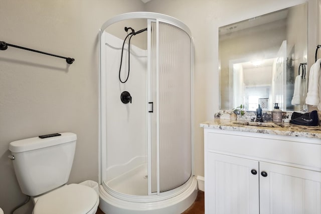 bathroom with vanity, toilet, and walk in shower