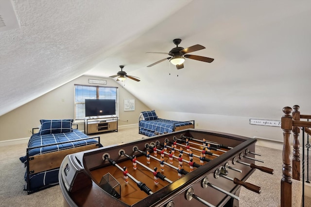 game room featuring lofted ceiling, light colored carpet, and a textured ceiling