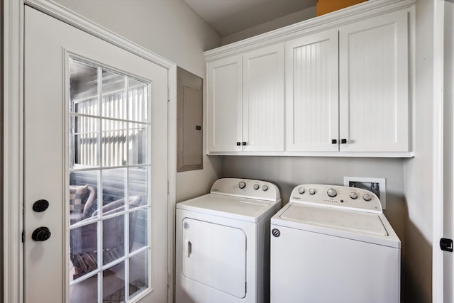 laundry room with electric panel, cabinets, and washing machine and clothes dryer