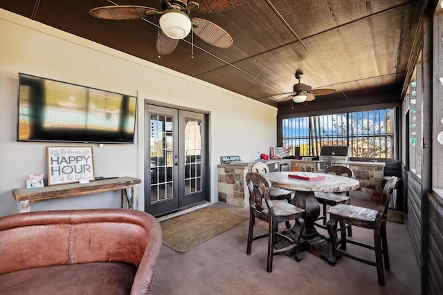 sunroom featuring french doors, ceiling fan, and wood ceiling