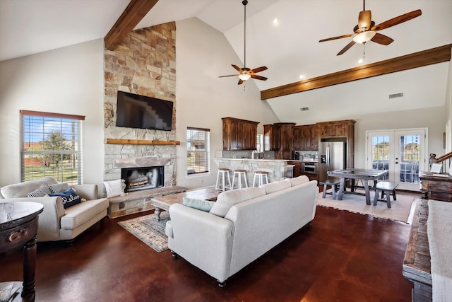 living room featuring ceiling fan, high vaulted ceiling, a fireplace, french doors, and beamed ceiling