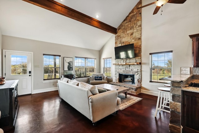 living room with high vaulted ceiling, a healthy amount of sunlight, a fireplace, and beam ceiling