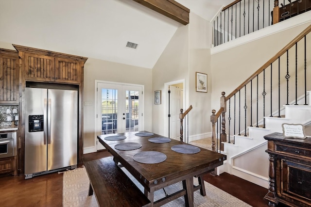 dining area featuring high vaulted ceiling and french doors