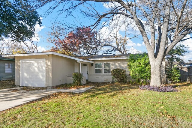 single story home featuring a front lawn and a garage