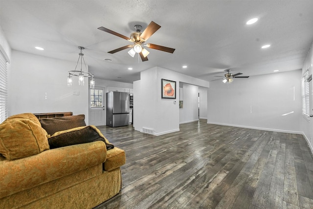 living room with dark hardwood / wood-style floors and ceiling fan