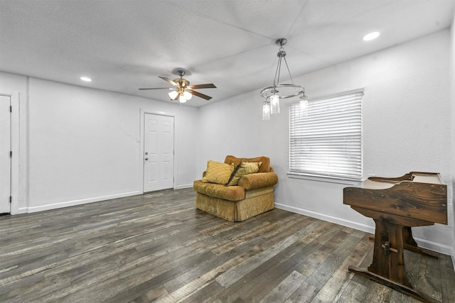 sitting room featuring a textured ceiling, dark hardwood / wood-style floors, and ceiling fan