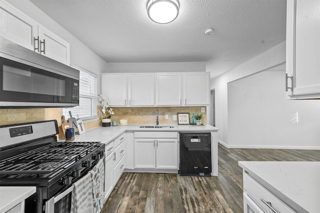 kitchen with sink, white cabinetry, dark hardwood / wood-style flooring, stainless steel appliances, and decorative backsplash