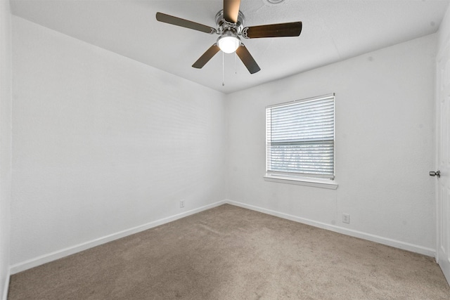 spare room featuring ceiling fan and light carpet