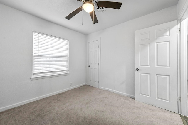 empty room with light colored carpet and ceiling fan