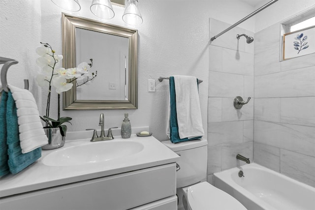 full bathroom featuring vanity, toilet, and tiled shower / bath