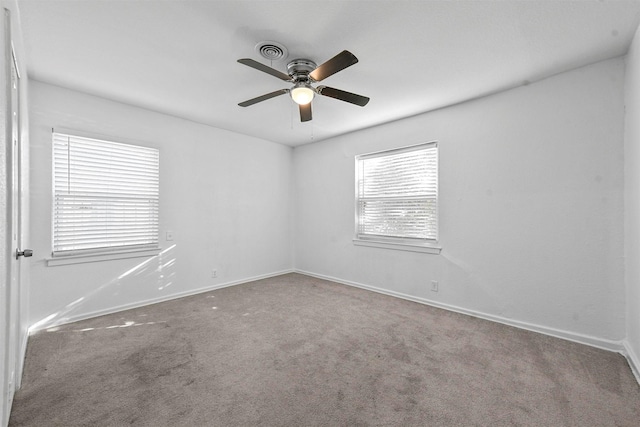 spare room with carpet floors and ceiling fan