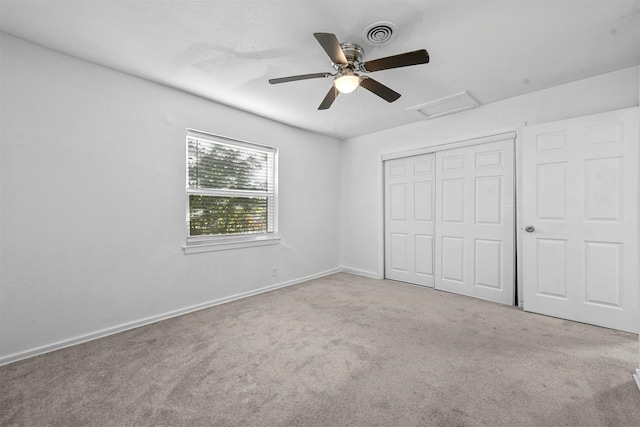 unfurnished bedroom with light carpet, a closet, and ceiling fan